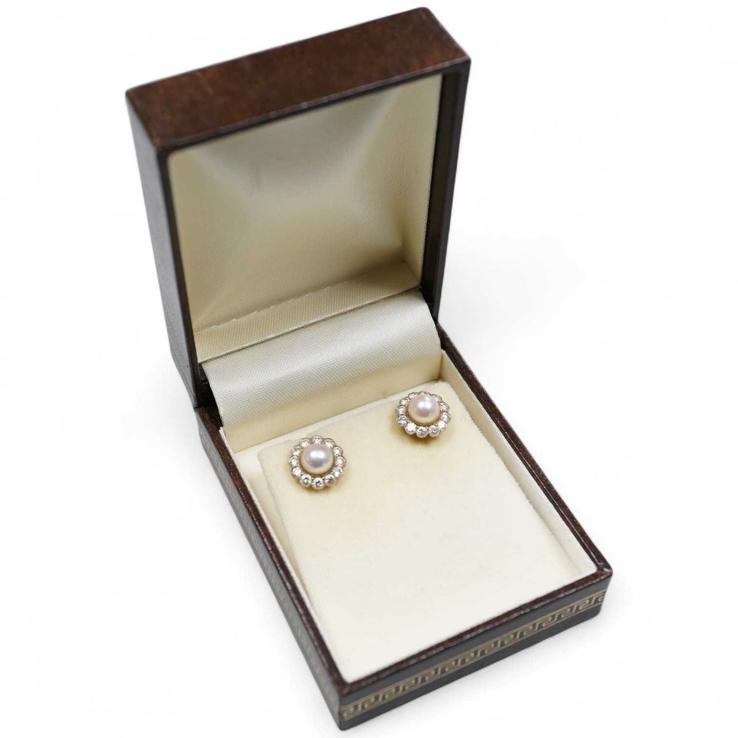 A pair of cultured pearl and diamond cluster earrings, each set with a cultured pearl, within a border of brilliant-cut diamonds, totalling approximately 1.20 carats, mounted in gold, post fittings, diameter 1.2cm each,